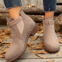 Women's buckle strap booties worn outdoors